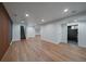 Finished basement rec room with plank flooring and multiple rooms at 1746 Shavano St, Longmont, CO 80504