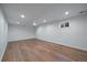 Basement room with plank flooring, a small window, and recessed lighting at 1746 Shavano St, Longmont, CO 80504