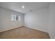 Basement bedroom with carpeted floors, a window, and recessed lighting at 1746 Shavano St, Longmont, CO 80504