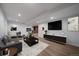 Finished basement living room space with plank flooring and entertainment center at 1746 Shavano St, Longmont, CO 80504