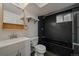 Modern bathroom featuring a black tiled shower-tub combination and updated vanity and fixtures at 1746 Shavano St, Longmont, CO 80504