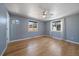 Spacious bedroom featuring hardwood floors, two windows, ceiling fan, and neutral paint at 1746 Shavano St, Longmont, CO 80504