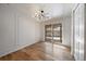 Light-filled dining room with hardwood floors and modern chandelier, with sliding glass doors at 1746 Shavano St, Longmont, CO 80504