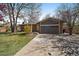 A close view of the house showing the two-car garage, and manicured front lawn at 1746 Shavano St, Longmont, CO 80504