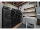 Functional laundry room featuring a modern washer and dryer set and utility sink at 1746 Shavano St, Longmont, CO 80504