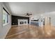 Open living room with hardwood floors, a fireplace, and eat-in kitchen with bar seating at 1746 Shavano St, Longmont, CO 80504
