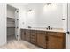 Contemporary bathroom boasts a double vanity with wood cabinets, sleek black fixtures, and stylish tile flooring at 6845 Fawn Path Way, Castle Pines, CO 80108