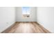 Bedroom featuring hardwood floors, a window, and white walls with minimalist design at 6845 Fawn Path Way, Castle Pines, CO 80108