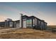 Modern home with stone accents, large windows, and a well-maintained landscape in a desirable neighborhood at 6845 Fawn Path Way, Castle Pines, CO 80108