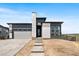 Beautiful new construction home boasts a modern design with stone accents and a welcoming entrance at 6845 Fawn Path Way, Castle Pines, CO 80108