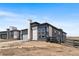 Modern home with stone accents, large windows, and a well-maintained landscape in a desirable neighborhood at 6845 Fawn Path Way, Castle Pines, CO 80108