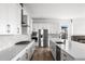 Modern kitchen with stainless steel appliances, quartz countertops, and a large island, perfect for cooking at 6845 Fawn Path Way, Castle Pines, CO 80108