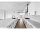 Bright, modern kitchen features white cabinets, marble countertops, and stainless steel appliances at 6845 Fawn Path Way, Castle Pines, CO 80108