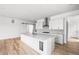 Bright, modern kitchen with white cabinets, large island, and stainless steel appliances at 6845 Fawn Path Way, Castle Pines, CO 80108
