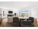 Bright living room with fireplace, TV, table and sliding doors to outdoor patio at 6845 Fawn Path Way, Castle Pines, CO 80108