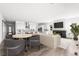 Bright and open living space featuring a fireplace, hardwood floors, and seamless flow to the kitchen at 6845 Fawn Path Way, Castle Pines, CO 80108