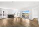 Bright and open living space featuring a fireplace, hardwood floors, and seamless flow to the kitchen at 6845 Fawn Path Way, Castle Pines, CO 80108