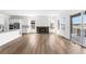 Bright and open living space featuring a fireplace, hardwood floors, and seamless flow to the kitchen at 6845 Fawn Path Way, Castle Pines, CO 80108