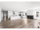 Bright and open living space featuring a fireplace, hardwood floors, and seamless flow to the kitchen at 6845 Fawn Path Way, Castle Pines, CO 80108