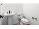 Stylish powder room with a pedestal sink, modern fixtures, and a clean, minimalist design for guests at 6845 Fawn Path Way, Castle Pines, CO 80108