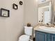 Stylish half bathroom with modern fixtures and decorative accents at 19430 E 58Th Dr, Aurora, CO 80019