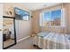 Bright bedroom with a large window and a mirrored wall for extra light at 19430 E 58Th Dr, Aurora, CO 80019