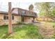 Spacious backyard featuring a brick house with a covered patio and a large grassy area at 6211 W Fremont Pl, Littleton, CO 80128
