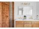 Modern bathroom with a luxurious walk-in shower with bronze tile and a double vanity with contemporary fixtures and a large mirror at 6211 W Fremont Pl, Littleton, CO 80128