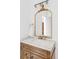 Elegant bathroom vanity boasting a marble countertop, ornate gold mirror, and stylish fixtures, adding a touch of luxury at 6211 W Fremont Pl, Littleton, CO 80128