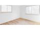 Bright bedroom featuring gleaming hardwood floors and large windows at 6211 W Fremont Pl, Littleton, CO 80128