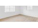Bright bedroom featuring gleaming hardwood floors and large windows at 6211 W Fremont Pl, Littleton, CO 80128