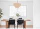 Modern dining room with stylish light fixture and seating for four at 6211 W Fremont Pl, Littleton, CO 80128
