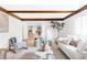 Bright, open-concept living room with wood beams and modern decor at 6211 W Fremont Pl, Littleton, CO 80128