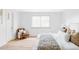 Inviting main bedroom featuring a cozy chair, bright window, and comfortable bed, creating a peaceful and relaxing environment at 6211 W Fremont Pl, Littleton, CO 80128