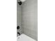Modern shower features sleek gray tiled walls and updated fixtures at 6211 W Fremont Pl, Littleton, CO 80128
