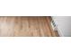 Attractive wood flooring with a light finish, enhanced by a clean white baseboard and vent, showcasing its natural beauty at 6211 W Fremont Pl, Littleton, CO 80128