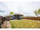 Spacious backyard with pergola-covered patio, a grilling area, and lush lawn at 2401 E 35Th Ave, Denver, CO 80205