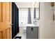 Bright bathroom with modern vanity, glass block window, and stylish fixtures at 2401 E 35Th Ave, Denver, CO 80205