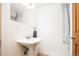 Bright bathroom with pedestal sink and fixtures, plus towel rack at 2401 E 35Th Ave, Denver, CO 80205