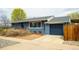 Charming blue house with a well-maintained yard and a convenient two-car garage at 2401 E 35Th Ave, Denver, CO 80205