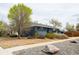 Charming single-story home with beautiful landscaping and a covered porch at 2401 E 35Th Ave, Denver, CO 80205