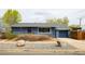 Charming single-story home featuring a brick facade, well-maintained landscaping, and an attached garage at 2401 E 35Th Ave, Denver, CO 80205