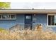 Charming front porch with a beautiful blue door and lovely yard at 2401 E 35Th Ave, Denver, CO 80205