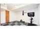 Home gym features gray and black checkerboard floor and exercise bike at 2401 E 35Th Ave, Denver, CO 80205