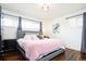 Comfortable main bedroom with natural light, hardwood floors, and a plush bed at 2401 E 35Th Ave, Denver, CO 80205