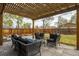 Cozy backyard patio with pergola, outdoor seating, and a well-maintained lawn at 2401 E 35Th Ave, Denver, CO 80205