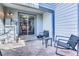 Outdoor patio with chairs, a table, and a sliding glass door leading to the interior at 14120 E Warren Pl, Aurora, CO 80014