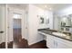 Bathroom featuring hardwood floors, mirror and cabinetry at 14120 E Warren Pl, Aurora, CO 80014