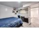 Spacious bedroom featuring a dark-wood bed, a window, and shelves with plush toys at 14120 E Warren Pl, Aurora, CO 80014