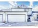 Inviting two-story home showcasing a spacious two car garage, neutral siding, trimmed in gray, and a well manicured front yard at 14120 E Warren Pl, Aurora, CO 80014
